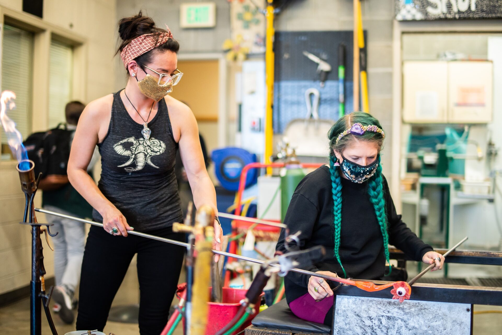 Hot Glass Demonstration of eyeball flower. Bri takes a hot bit from Minhi